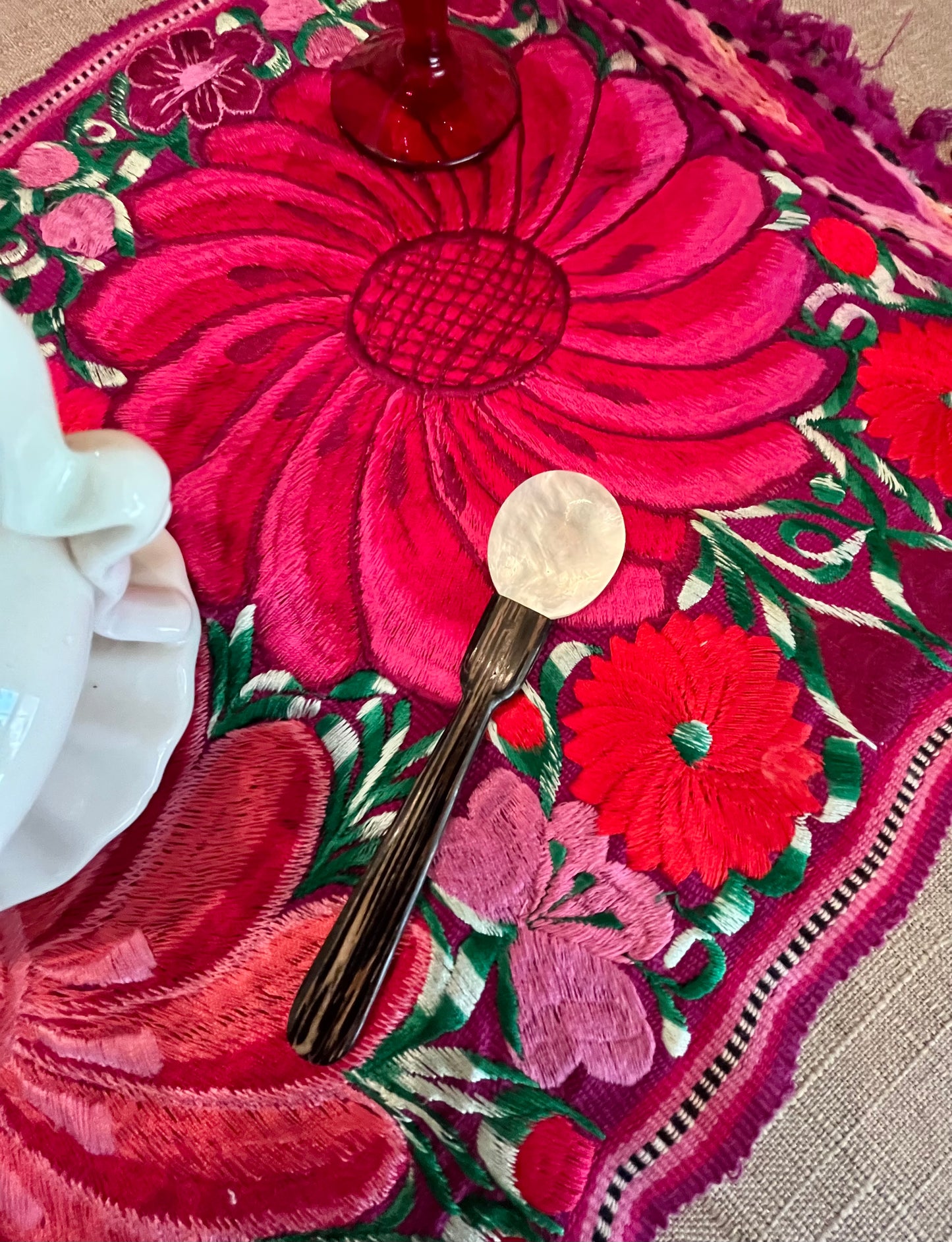 MotherofPearlCaviarBalsaWoodCaviarSpoon on Pink embroidered multi color floral place mat